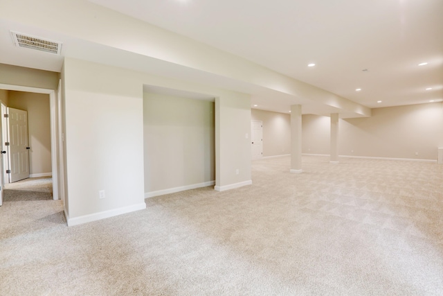 basement featuring light carpet