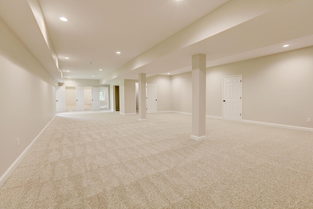 basement featuring light colored carpet