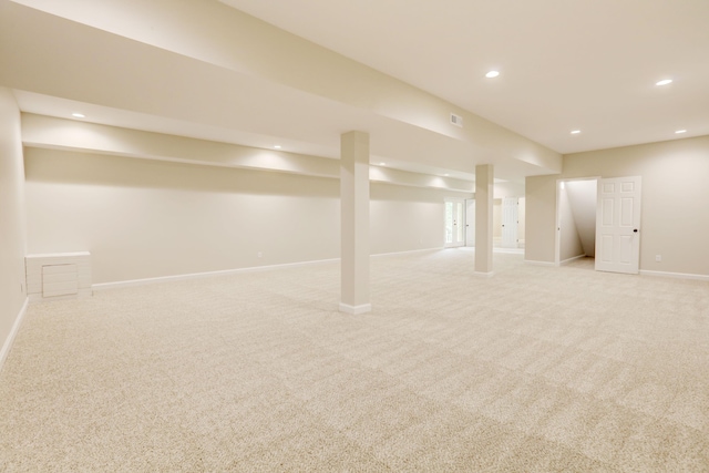 basement featuring light carpet