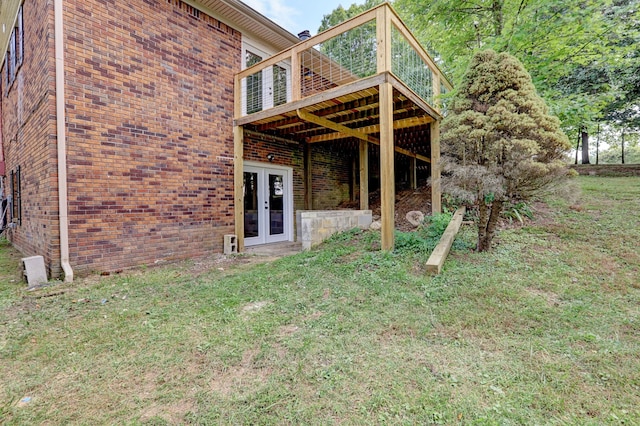 view of yard featuring french doors and a wooden deck