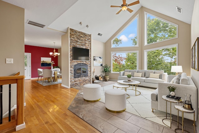706 Hunter Dr, Lancaster, KY 40444 - living room featuring visible vents, high vaulted ceiling, light wood-style flooring, and ceiling fan with notable chandelier