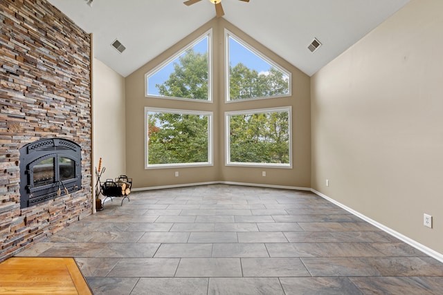 unfurnished living room featuring high vaulted ceiling and ceiling fan