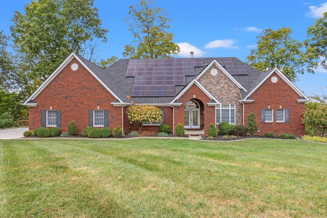 706 Hunter Dr, Lancaster, KY 40444 - view of front of house with solar panels, a front yard, brick siding, and roof with shingles