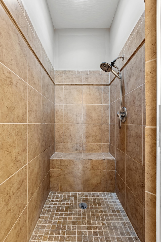 bathroom with tiled shower