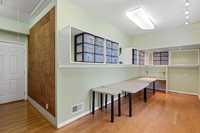 706 Hunter Dr, Lancaster, KY 40444 - home office featuring visible vents, a textured ceiling, wood finished floors, baseboards, and attic access