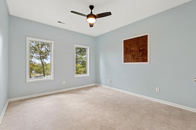 unfurnished room featuring ceiling fan and light carpet