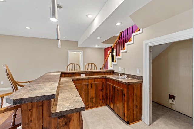 706 Hunter Dr, Lancaster, KY 40444 - kitchen with dark countertops, a breakfast bar area, recessed lighting, a peninsula, and a sink