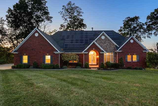 706 Hunter Dr, Lancaster, KY 40444 - view of front of house featuring brick siding, roof mounted solar panels, and a front yard