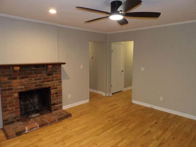 unfurnished living room with ceiling fan, light wood-type flooring, a brick fireplace, and ornamental molding