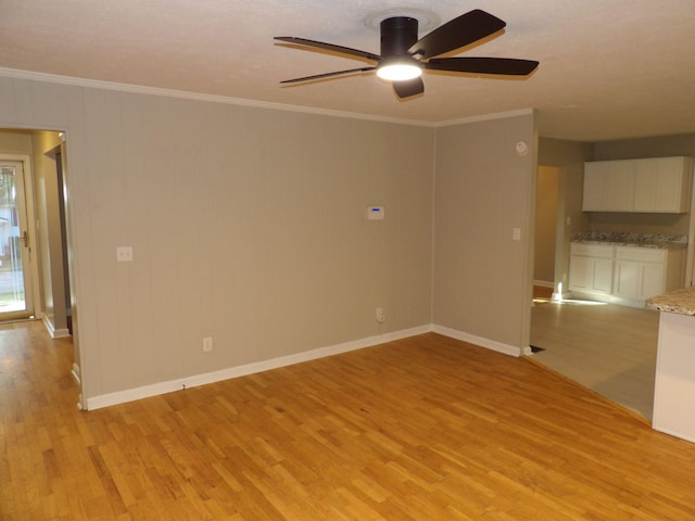 empty room with light hardwood / wood-style flooring, ceiling fan, and ornamental molding