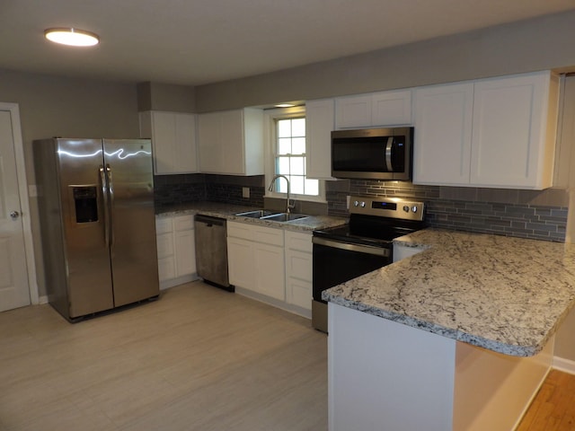 kitchen with light hardwood / wood-style flooring, white cabinets, appliances with stainless steel finishes, and sink