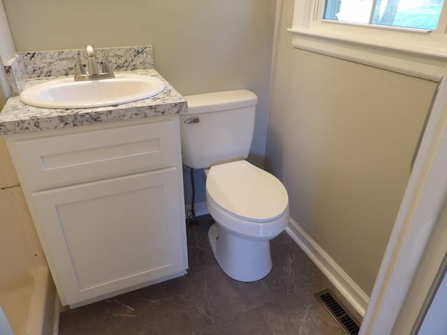 bathroom with vanity, toilet, and tile patterned floors