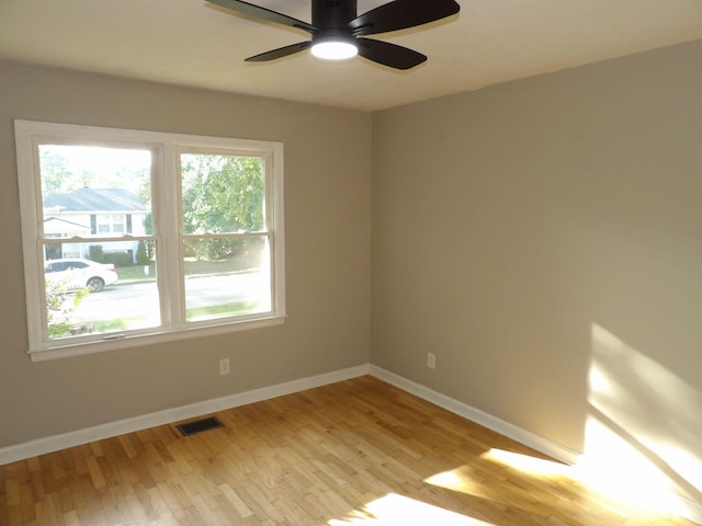 empty room with light hardwood / wood-style floors and ceiling fan