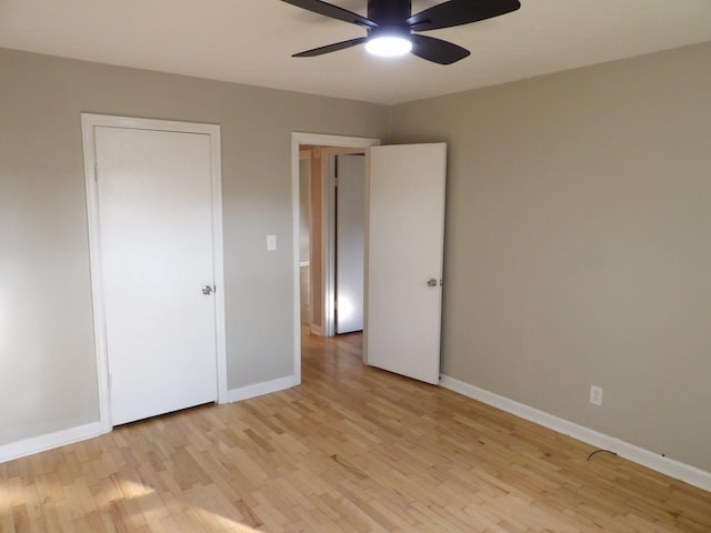 unfurnished bedroom featuring light wood-type flooring and ceiling fan