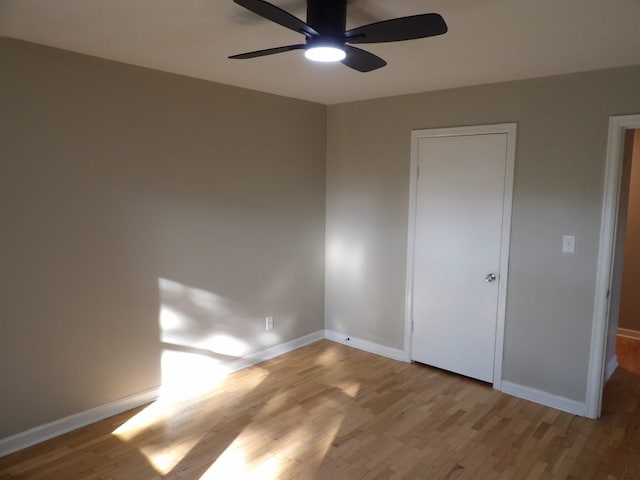 unfurnished bedroom featuring light wood-type flooring and ceiling fan