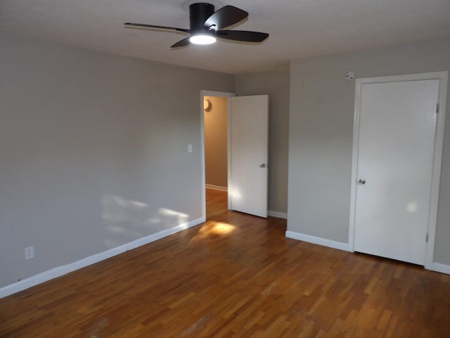 unfurnished room featuring ceiling fan and dark hardwood / wood-style floors