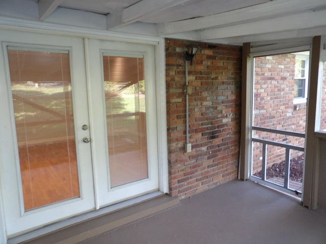 interior space with beam ceiling and a healthy amount of sunlight