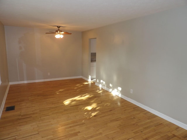 unfurnished room featuring ceiling fan and light wood-type flooring