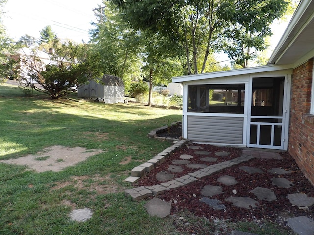 view of yard with a sunroom and a shed