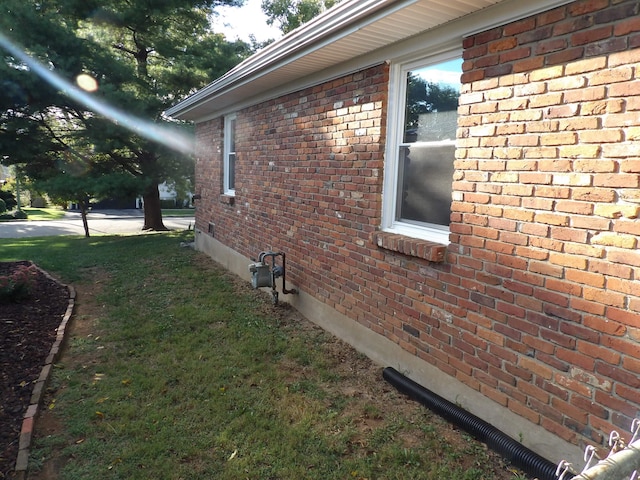 view of side of home featuring a lawn