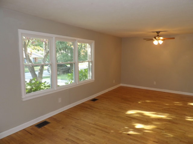 empty room featuring ceiling fan and hardwood / wood-style floors