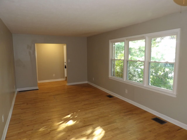 unfurnished room with light hardwood / wood-style floors