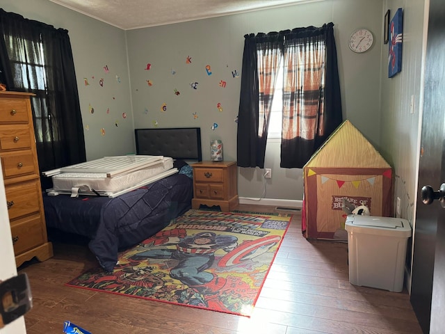 bedroom featuring a textured ceiling and hardwood / wood-style floors