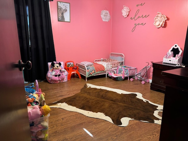 bedroom with hardwood / wood-style flooring