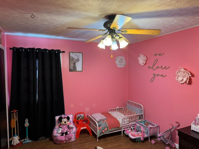 unfurnished bedroom featuring ceiling fan, hardwood / wood-style flooring, and a textured ceiling