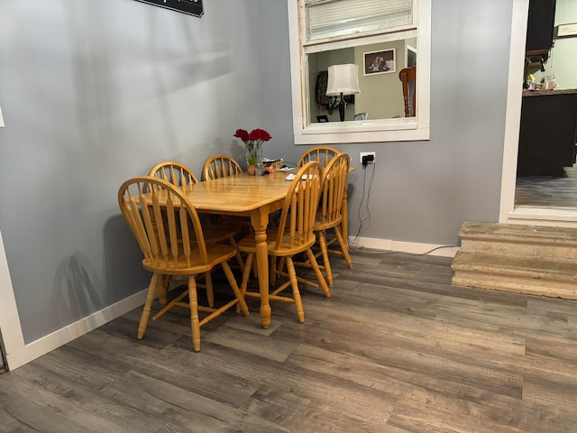 dining space with dark wood-type flooring