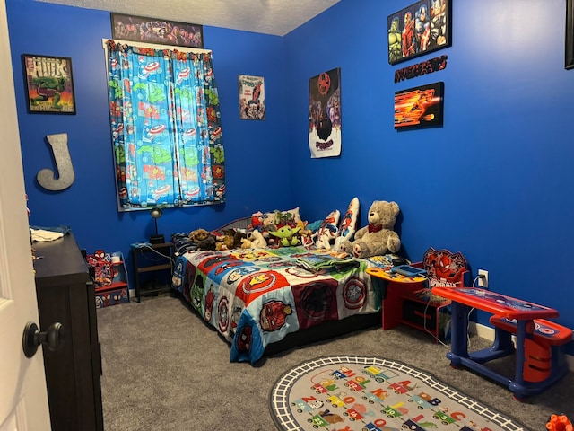 bedroom with a textured ceiling and carpet flooring