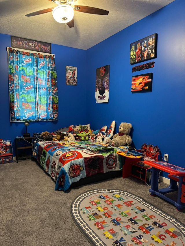 bedroom featuring ceiling fan, a textured ceiling, and carpet