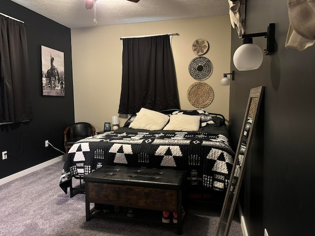 bedroom featuring dark carpet, ceiling fan, and a textured ceiling