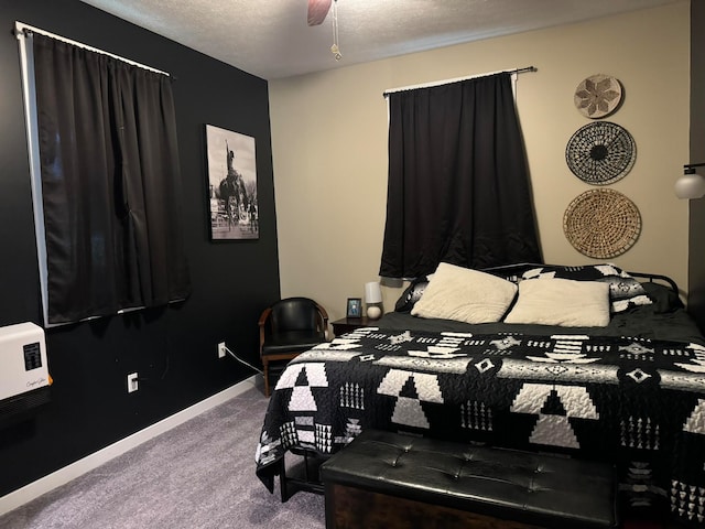 carpeted bedroom with a textured ceiling and ceiling fan