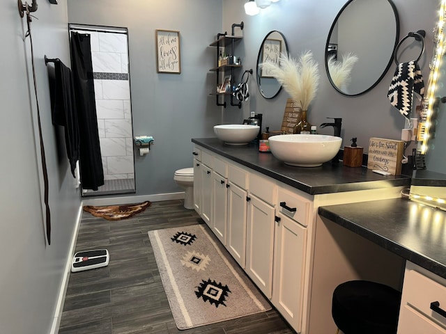 bathroom featuring vanity, toilet, a shower with shower curtain, and hardwood / wood-style flooring