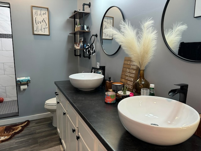 bathroom featuring wood-type flooring, vanity, and toilet