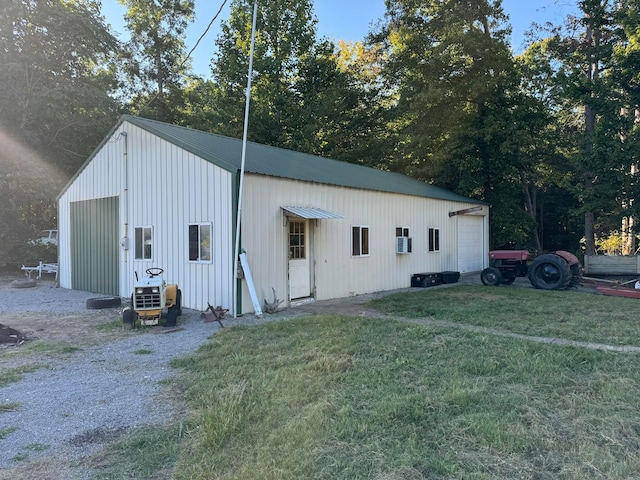 view of outbuilding with a garage and a yard