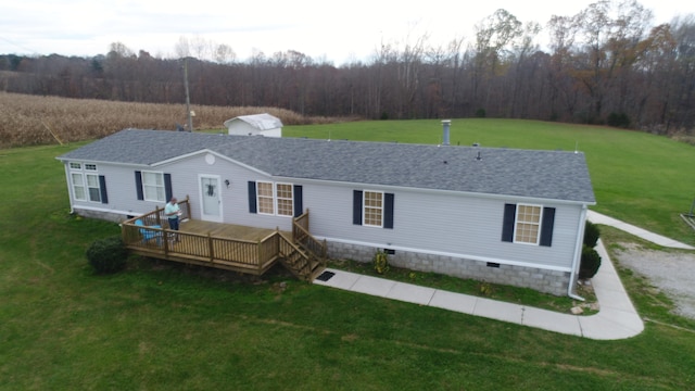 rear view of property featuring a lawn and a wooden deck