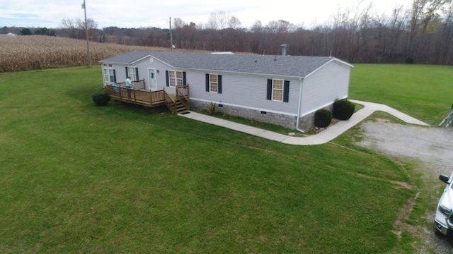 view of front of property with a wooden deck and a front yard