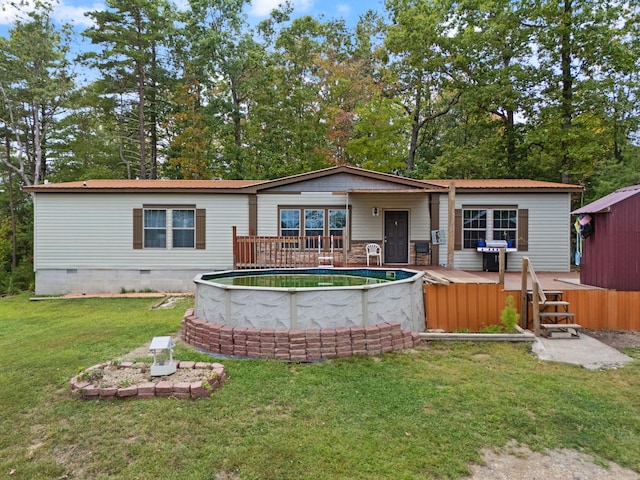 90 Damy Ln, Campton, KY 41301 - back of property featuring crawl space, an outdoor pool, a lawn, a deck, and a storage unit