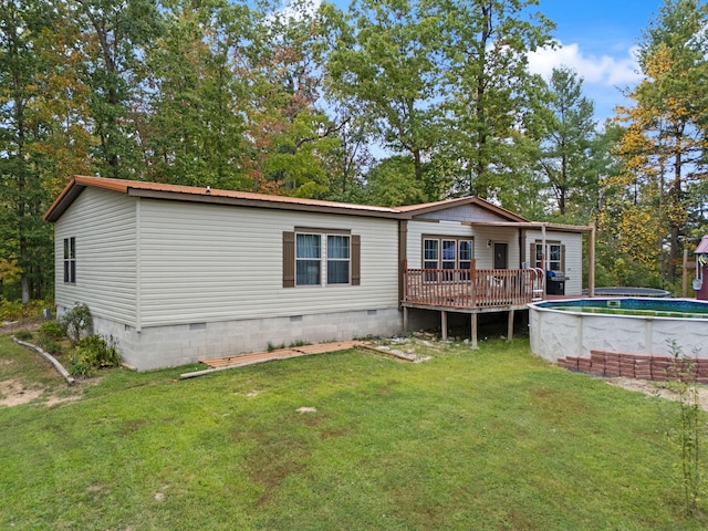 90 Damy Ln, Campton, KY 41301 - back of property featuring crawl space, a wooden deck, an outdoor pool, and a yard
