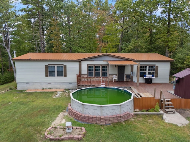 90 Damy Ln, Campton, KY 41301 - rear view of property with crawl space, a deck, metal roof, and a yard
