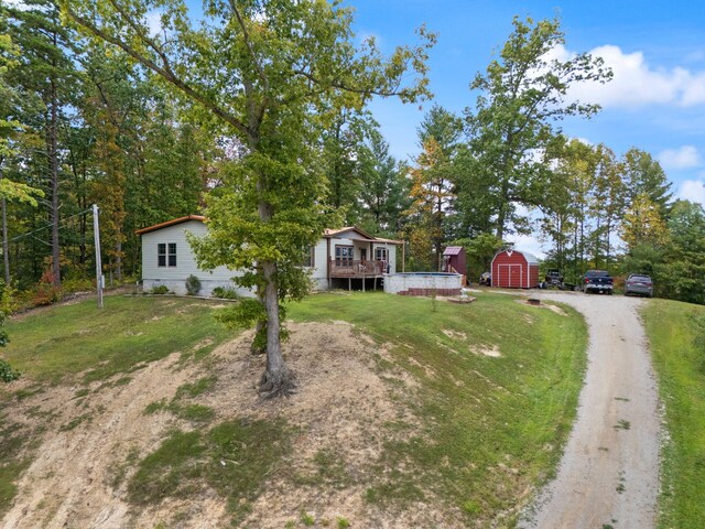 90 Damy Ln, Campton, KY 41301 - view of front of property with a wooden deck, dirt driveway, and a front yard