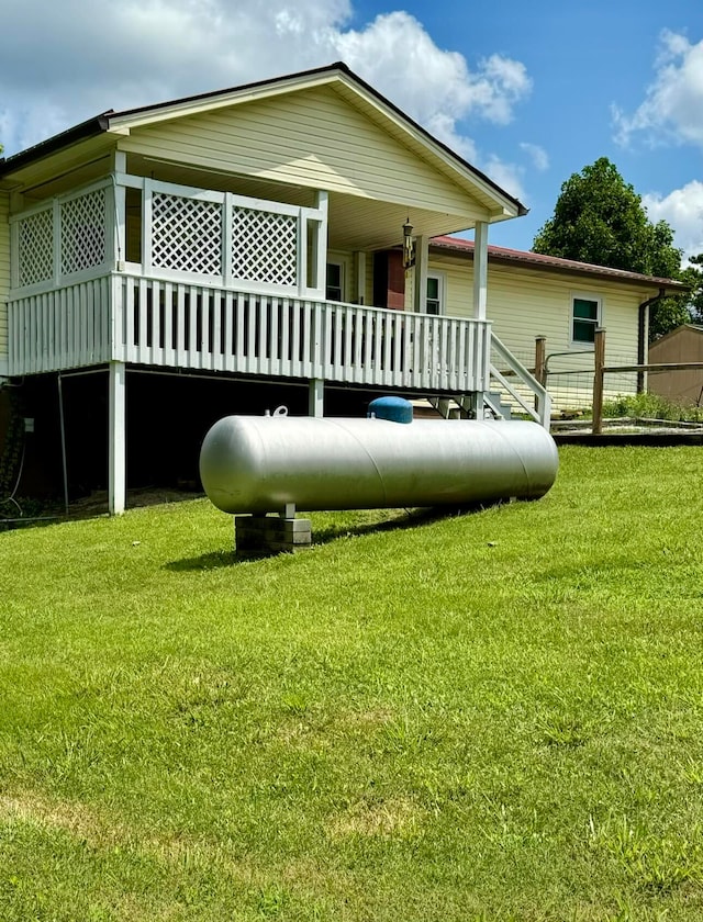 rear view of property featuring a yard