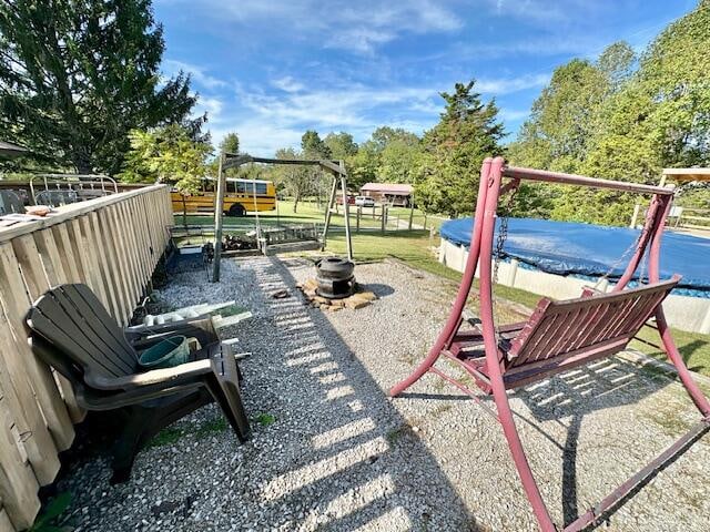 view of jungle gym featuring a covered pool