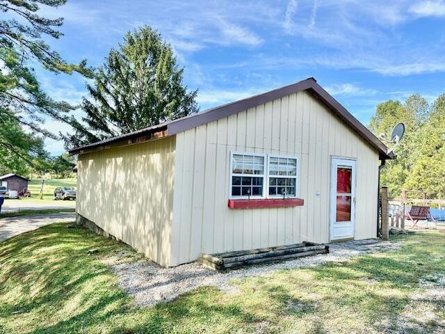 view of outbuilding with a lawn