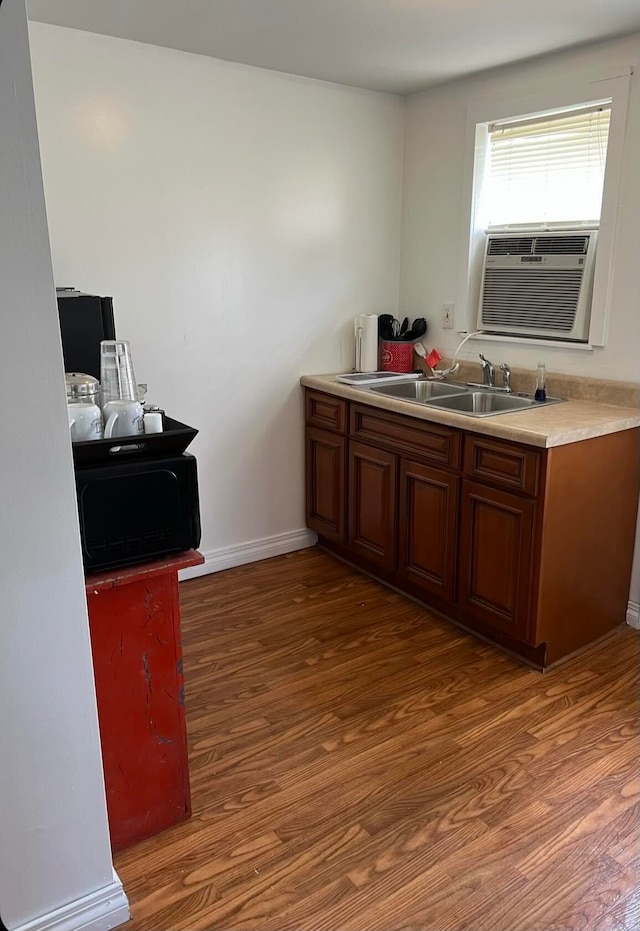 kitchen featuring cooling unit, dark hardwood / wood-style floors, and sink