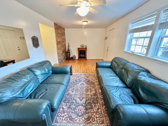 living room with wood-type flooring and ceiling fan