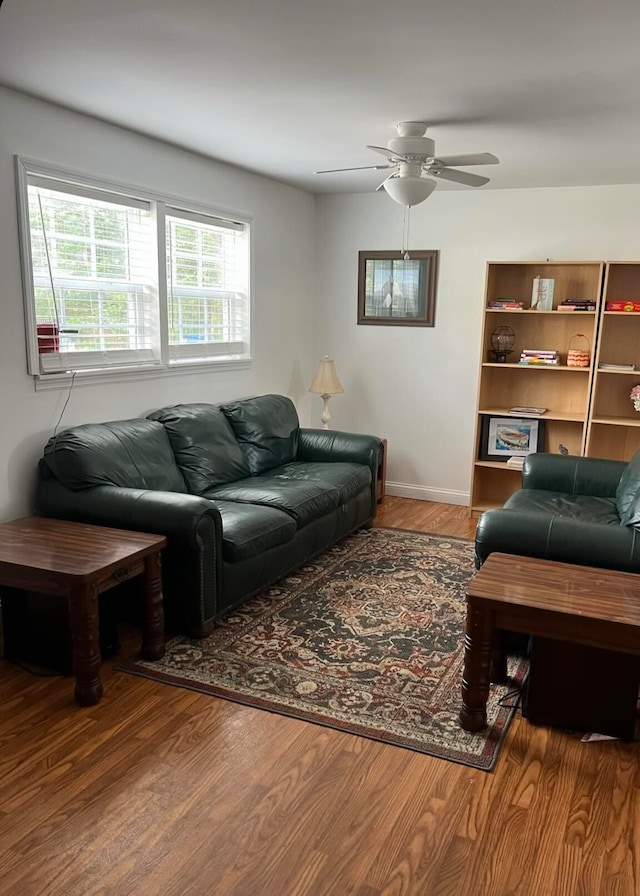 living room with wood-type flooring and ceiling fan