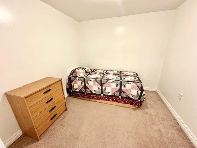 bedroom with light colored carpet